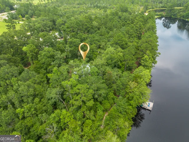 an aerial view of a house with a yard