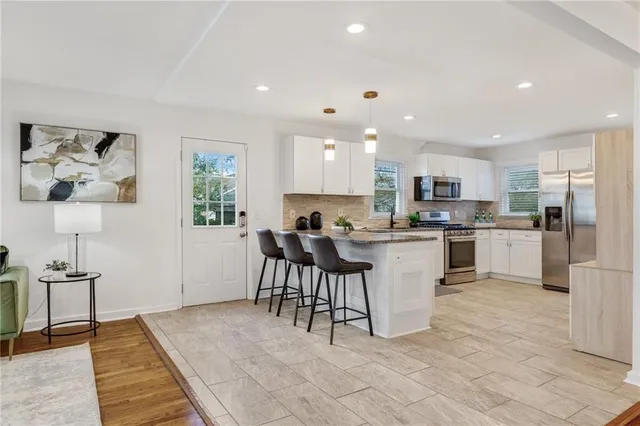 a kitchen with a refrigerator and a sink