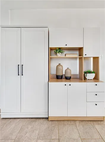 a kitchen with white cabinets and white appliances