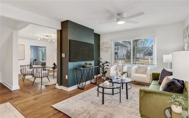 a living room with furniture and a wooden floor