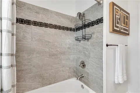 a bathroom with a bathtub and shower