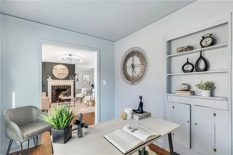 a view of a workspace with furniture and a mirror