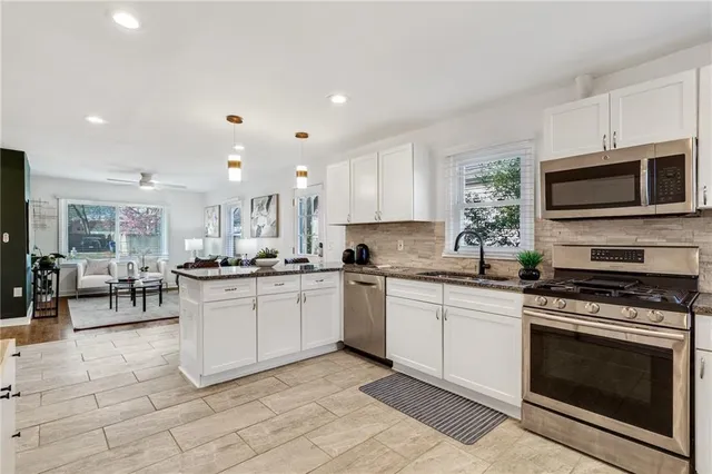 a kitchen with a sink cabinets and stainless steel appliances