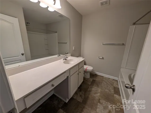 a bathroom with a double vanity sink and mirror