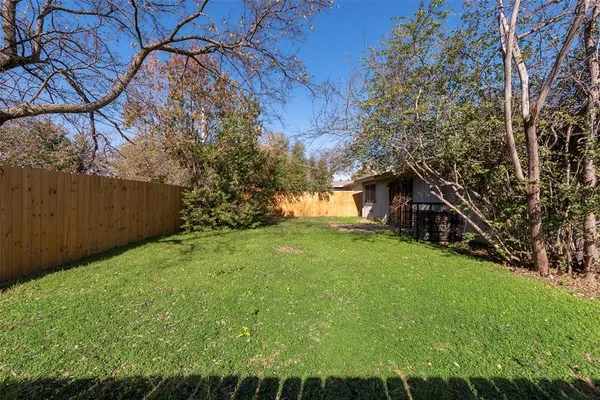 a view of a backyard with large trees