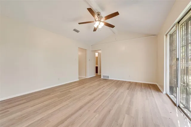 wooden floor in an empty room with a window