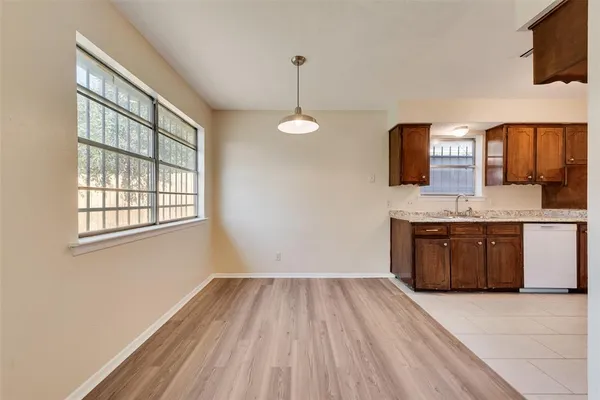 a kitchen with a wooden floor and window