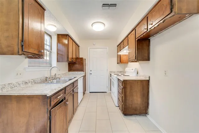 a bathroom with a sink double vanity granite and a mirror