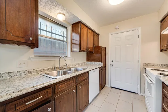 a kitchen with a sink and a refrigerator