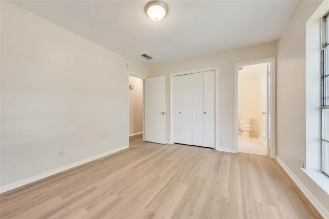 a view of an empty room and wooden floor
