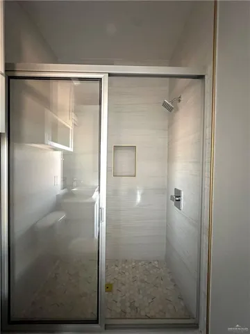 a bathroom with a glass shower door