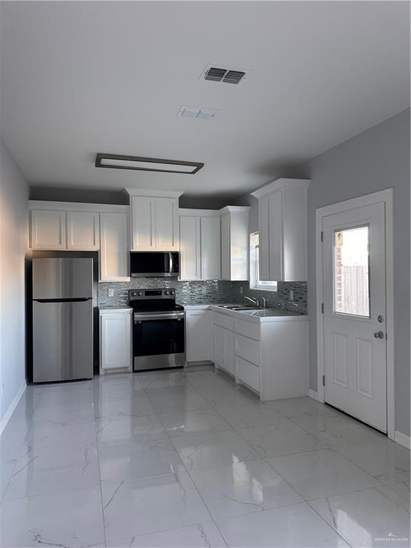 1038 Yellow Hammer Street Rio Grande City, TX 78582 - Photo 4 of 20 a kitchen with a refrigerator and a stove