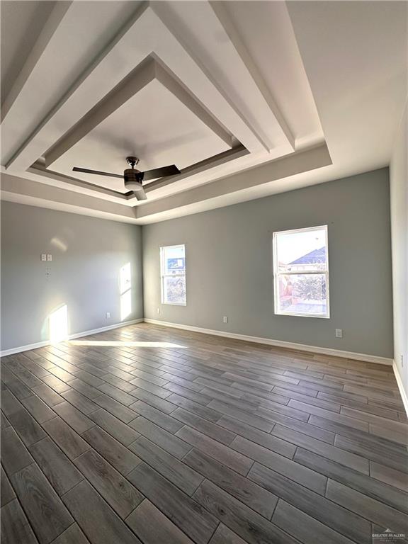 1038 Yellow Hammer Street Rio Grande City, TX 78582 - Photo 7 of 20 an empty room with wooden floor fan and windows