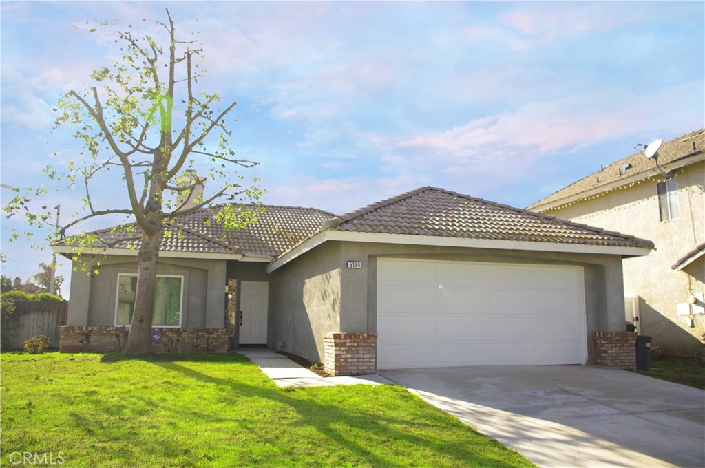 5174 Sierra Cross Way Riverside, CA 92509 - Photo 1 of 1 a front view of a house with a yard and garage