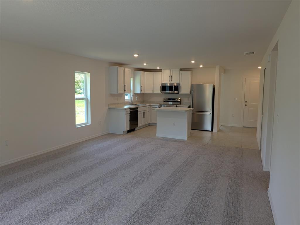 9065 107th Court Vero Beach, FL 32967 - Photo 11 of 40 a view of kitchen with sink microwave and refrigerator