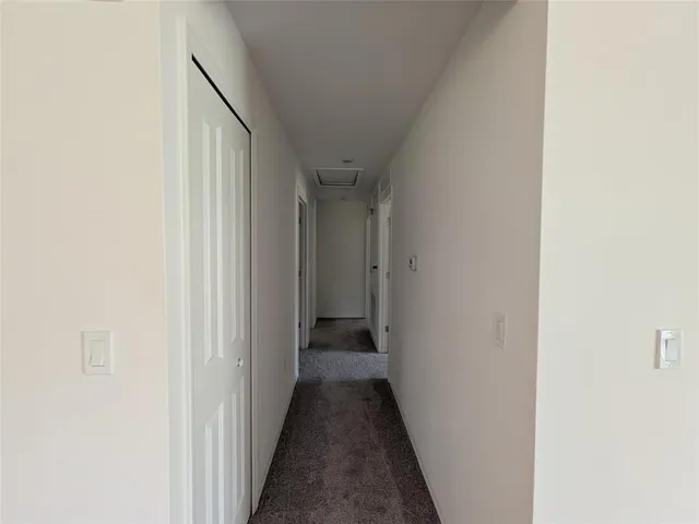 a view of a hallway with a white walls