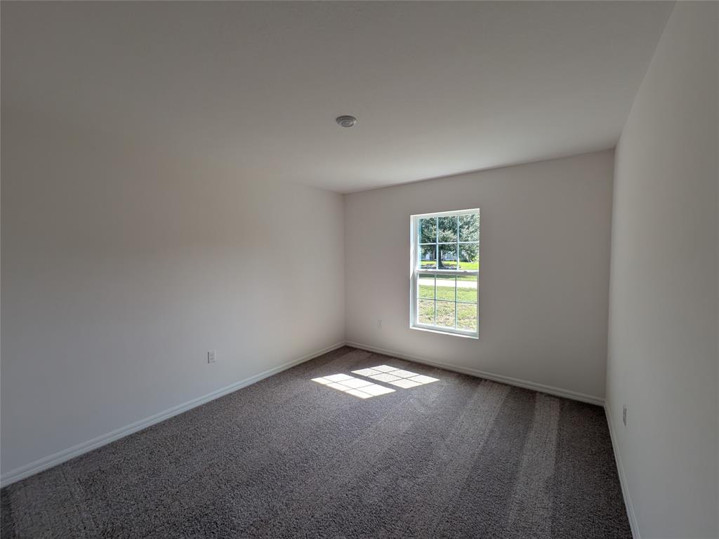 9065 107th Court Vero Beach, FL 32967 - Photo 22 of 40 a view of an empty room and window