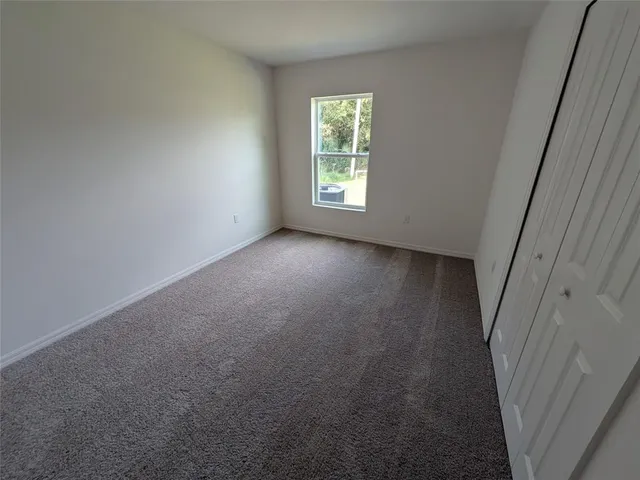 an empty room with windows and entrance