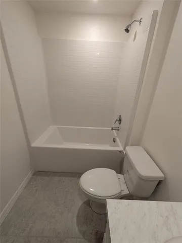 a bathroom with a toilet and a bathtub
