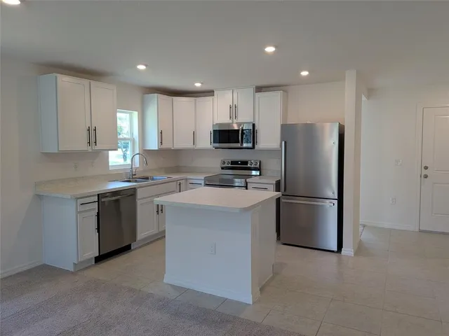 a kitchen with a refrigerator sink and microwave