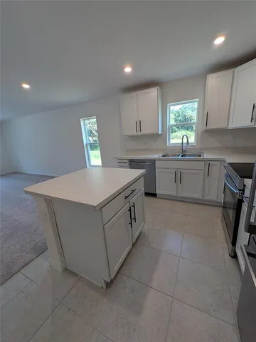 a kitchen with a cabinets and window