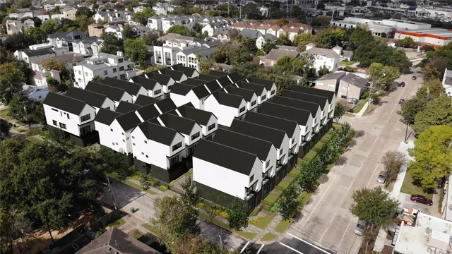 an aerial view of residential houses with outdoor space