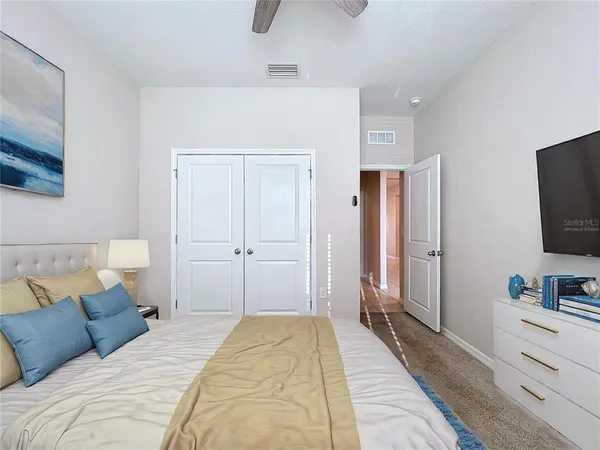 a bedroom with a bed and a flat screen tv