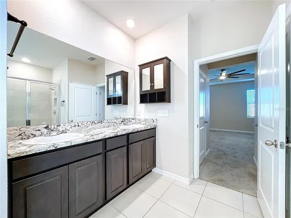 a bathroom with a granite countertop sink and a mirror