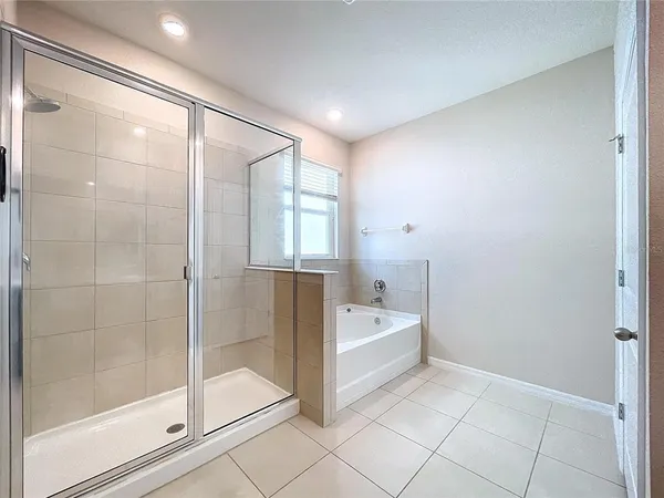 a bathroom with a bathtub and shower