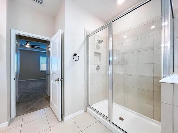 a bathroom with a glass shower door