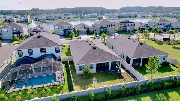 an aerial view of a house with a big yard