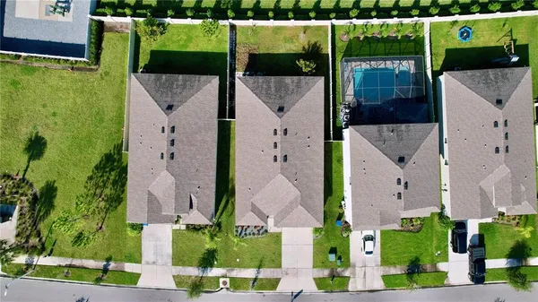 an aerial view of a house with a yard