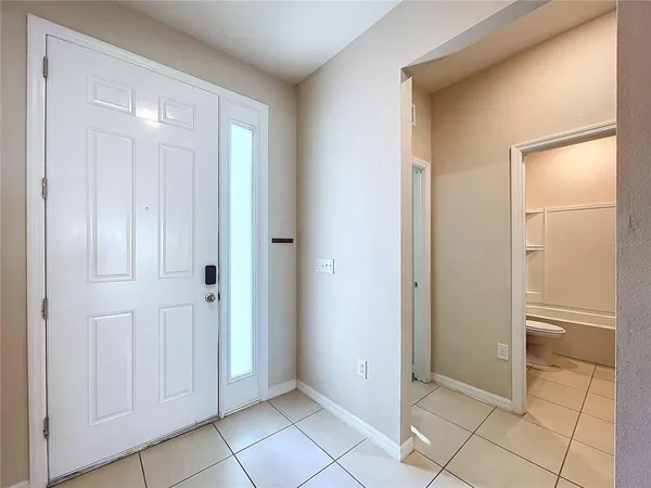 a view of a elevator and an empty room with windows
