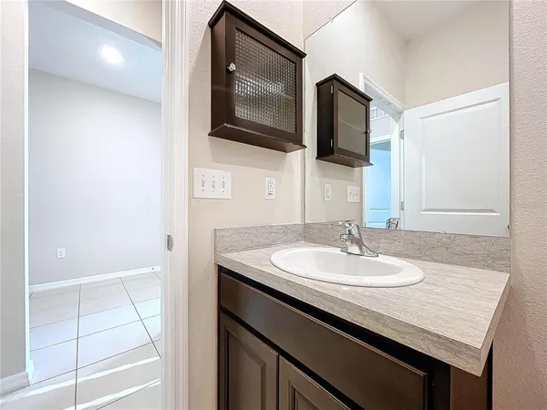 a bathroom with a sink a mirror and vanity