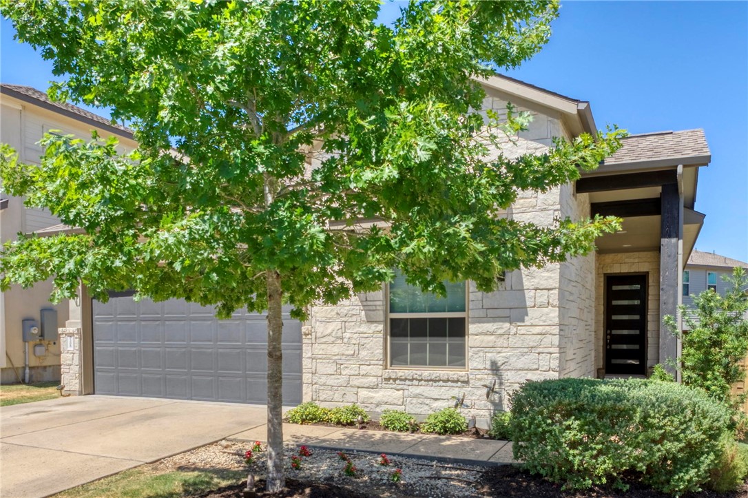 7308 Preserve View Run, Unit 52 Austin, TX 78726 - Photo 1 of 1 a front view of a house with plants