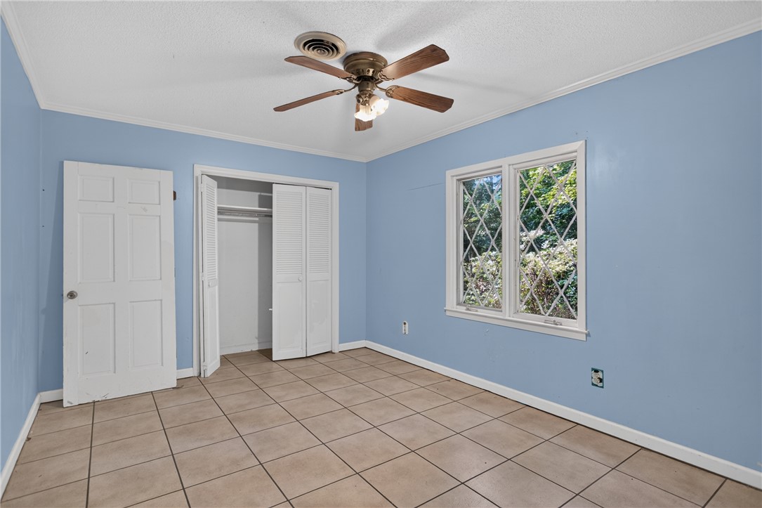 123 Robin Road Westminster, SC 29693 - Photo 35 of 50 A comfortable bedroom with tile flooring, bright window views, and ample closet space.