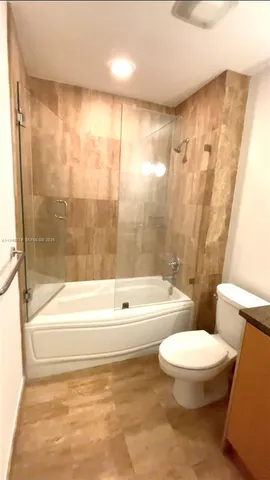 a bathroom with a bathtub and a toilet