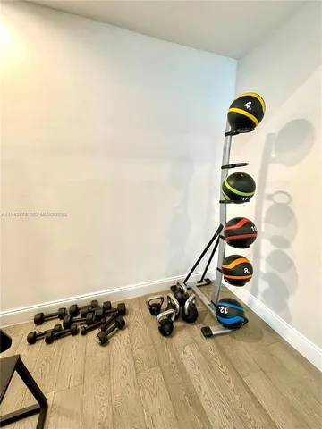 walk in closet with wooden floor