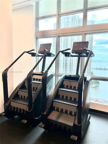 a view of gym equipment with large windows