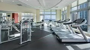a room with gym equipment and large mirror