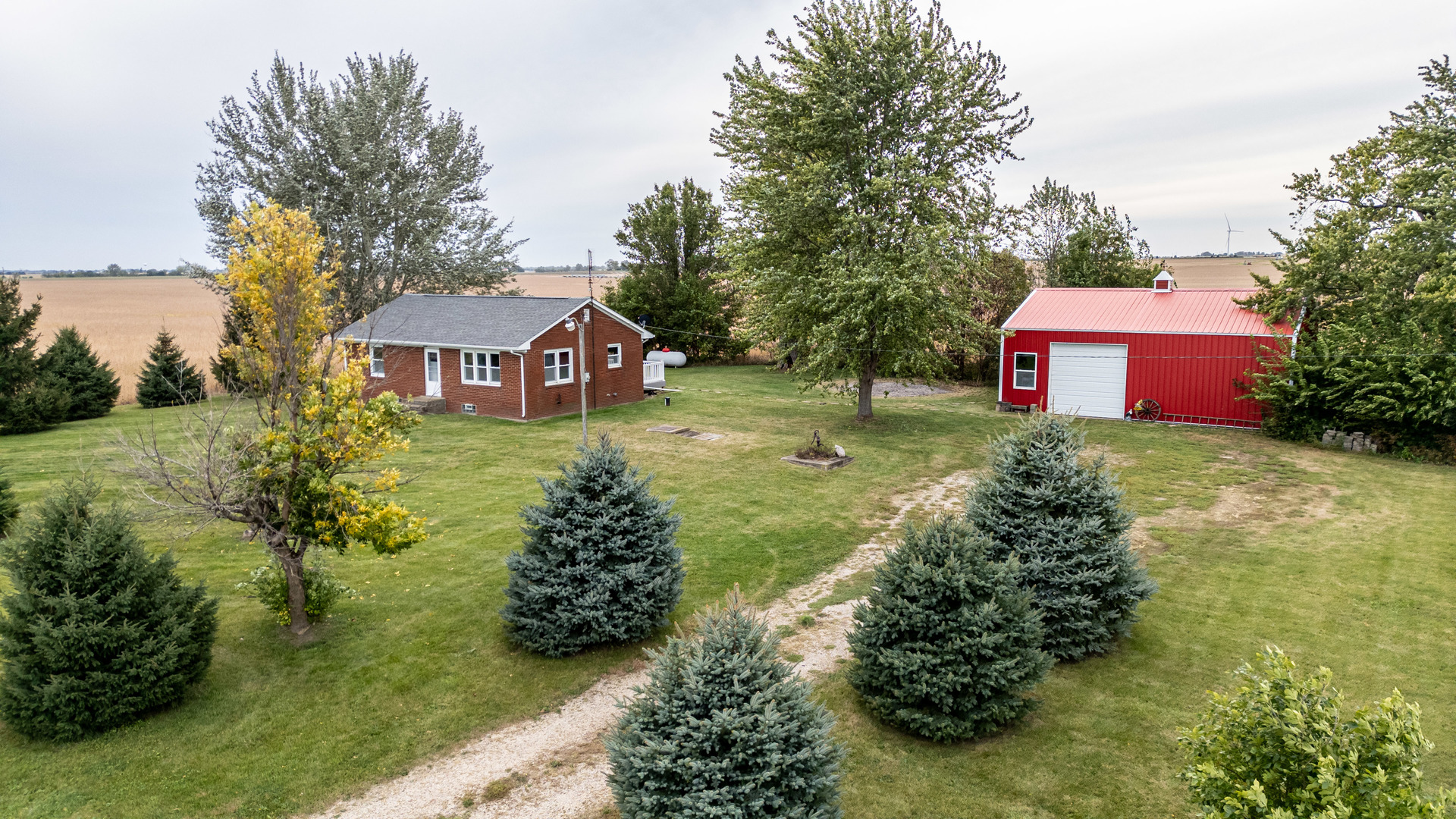 4705 East 7th Road Earlville, IL 60518 - Photo 14 of 21 a front view of a house with garden