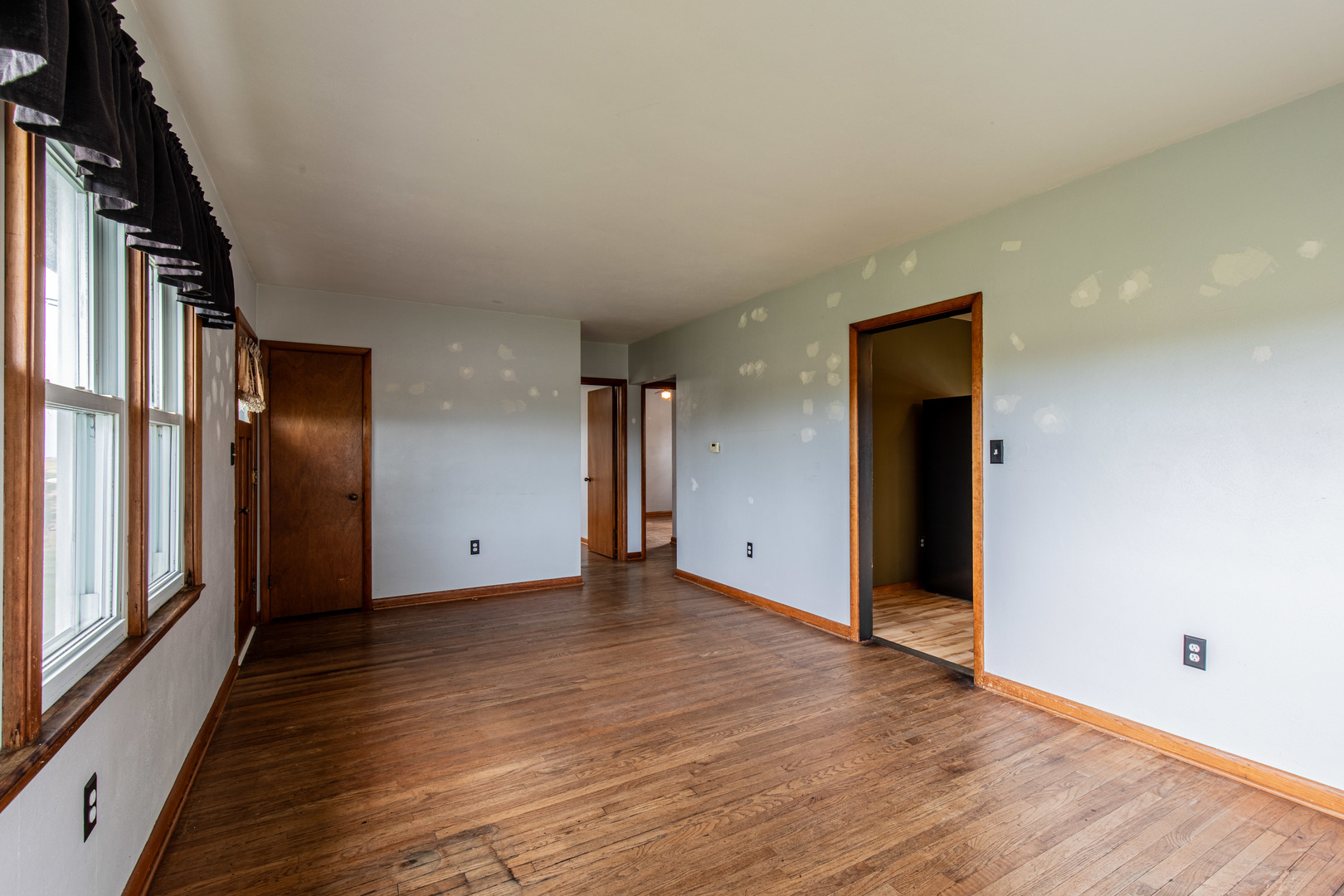 4705 East 7th Road Earlville, IL 60518 - Photo 3 of 21 a view of an empty room with wooden floor and a window