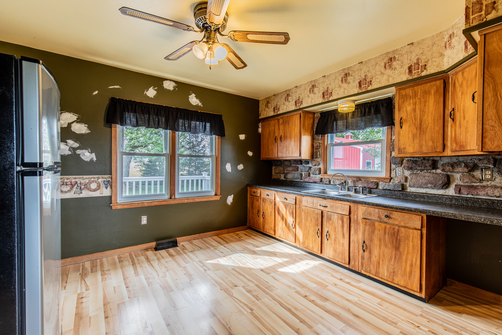 4705 East 7th Road Earlville, IL 60518 - Photo 4 of 21 a kitchen with stainless steel appliances granite countertop a sink window and cabinets