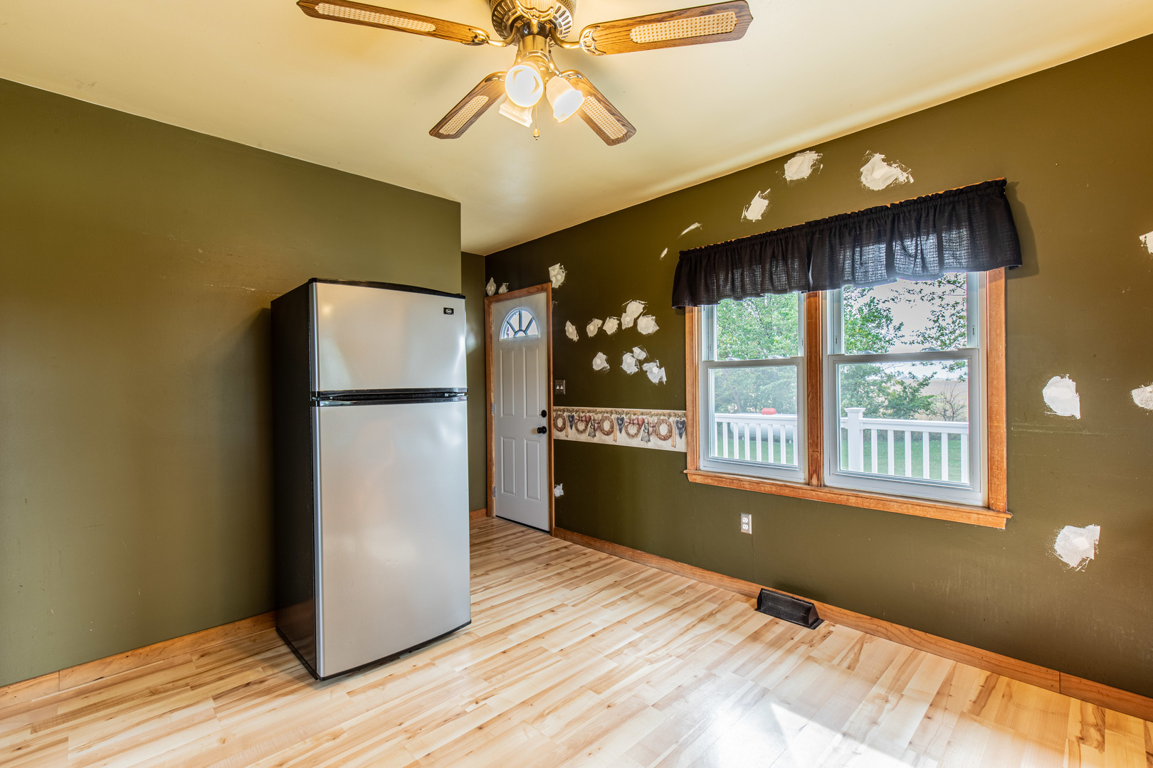 4705 East 7th Road Earlville, IL 60518 - Photo 6 of 21 a kitchen with stainless steel appliances granite countertop a refrigerator a stove and a wooden floors