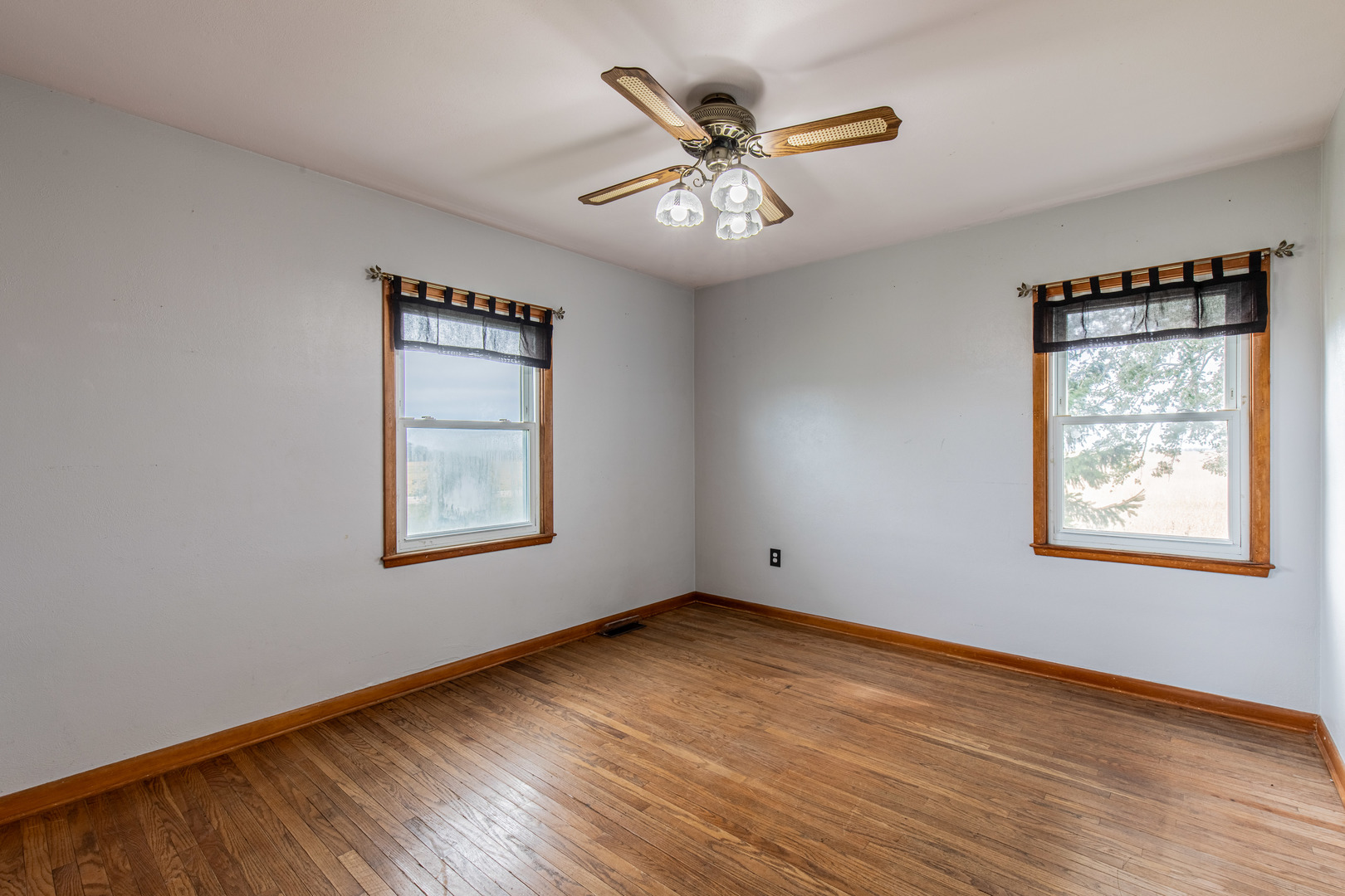 4705 East 7th Road Earlville, IL 60518 - Photo 7 of 21 a view of an empty room with wooden floor and a window