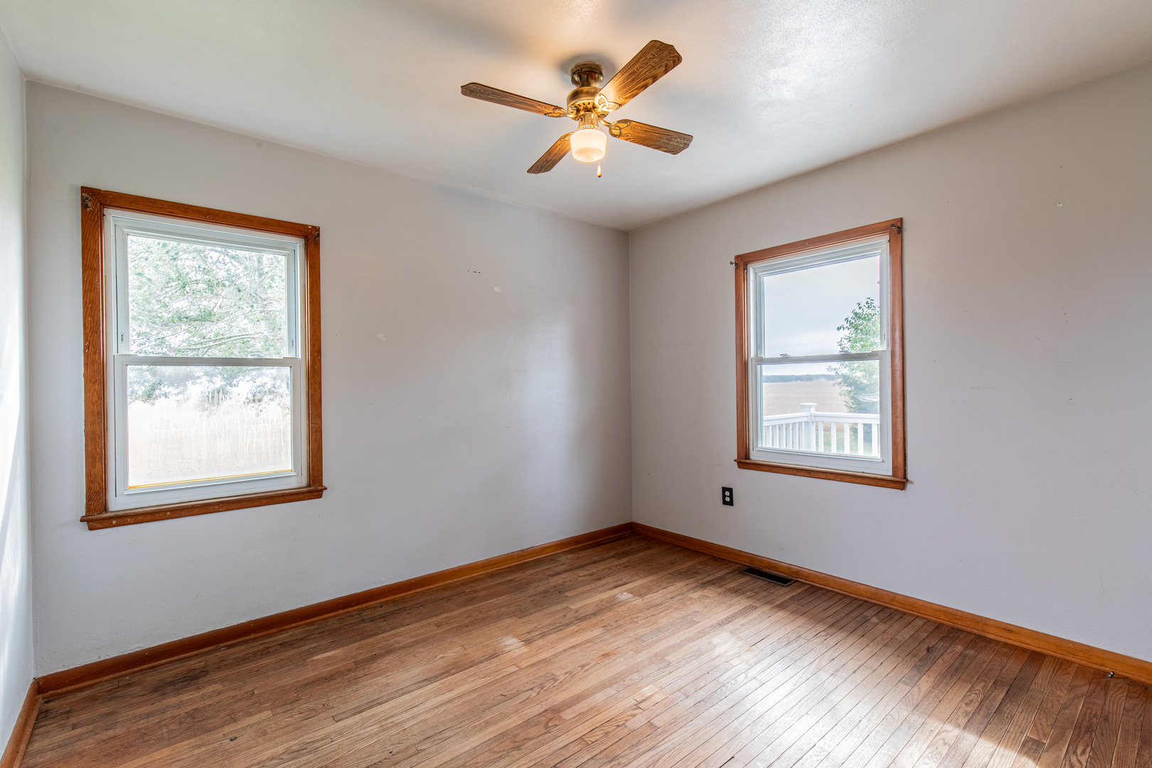 4705 East 7th Road Earlville, IL 60518 - Photo 8 of 21 a view of empty room with wooden floor and fan