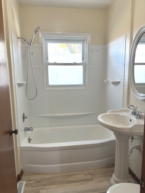 4705 East 7th Road Earlville, IL 60518 - Photo 9 of 21 a bathroom with a sink a window and a mirror