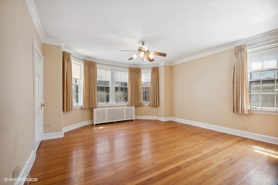 1316 Maple Avenue, Unit E1 Evanston, IL 60201 - Photo 3 of 11 a view of an empty room with a window and wooden floor