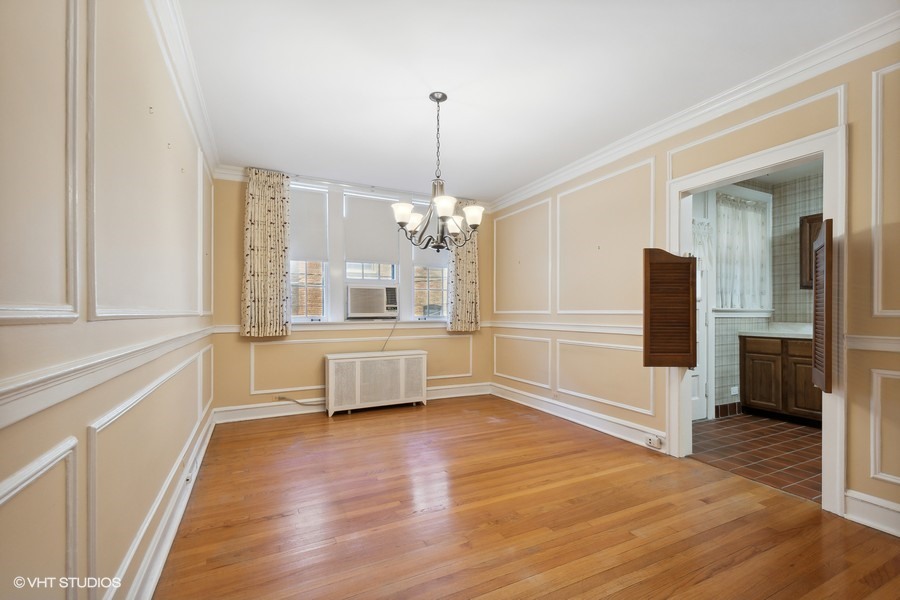 1316 Maple Avenue, Unit E1 Evanston, IL 60201 - Photo 5 of 11 a view of an empty room with window and wooden floor