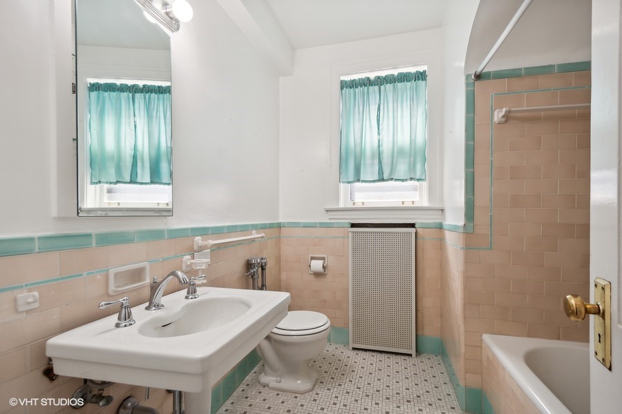 1316 Maple Avenue, Unit E1 Evanston, IL 60201 - Photo 7 of 11 a bathroom with a sink toilet and shower